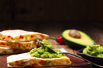 Quesadilla with chicken, served with guacamole or salsa sauce.