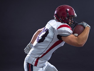 Fototapeta premium American football Player running with the ball