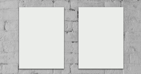 Two white sheets mock up design loft style with empty space for text on brick wall.