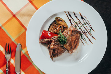 top view of grilled chicken with vegetables on plate on table napkin