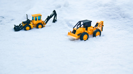 Two excavator stuck in the road due to snow.