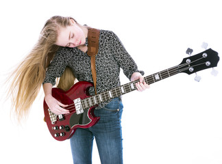 Obraz premium blond teen girl with red electric bass guitar against white background in studio