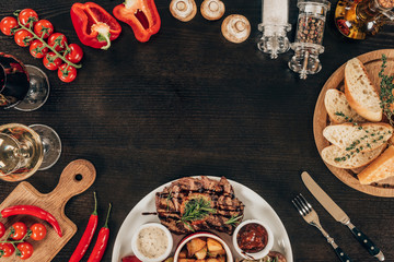 top view of fresh vegetables and cooked beef steak on table