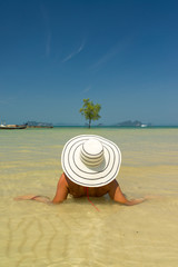 Fototapeta na wymiar woman resting at the tropical beach of Klong Muang in Thailand