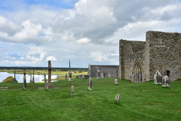 Tidal River Shannon with ruins and crosses of monastery of Clonmacnoise in Ireland.