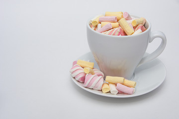 A cup of fragrant coffee with a colorful marshmallow.