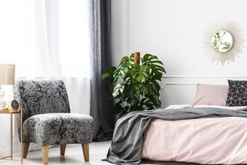 Patterned armchair in cozy bedroom