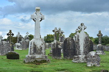 Fototapeta na wymiar Weathered tombstones mostly with Celtic crosses on grounds of monastery of Clonmacnoise in Ireland.