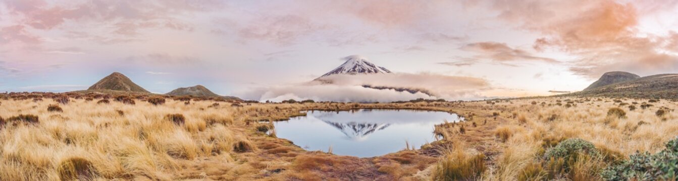 Reflection in Pouakai Tarn, stratovolcano Mount Taranaki or Mount Egmont at sunset, Egmont National Park, Taranaki, North Island, New Zealand, Oceania