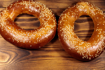 Bagels with sesame seeds on wooden table