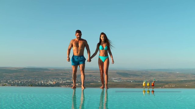 Couple jumping in pool