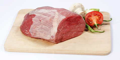 fresh raw red beef meat big steak chunk on wooden cut board isolated over white background