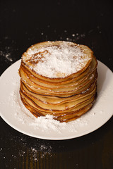 Pancakes in powdered sugar.