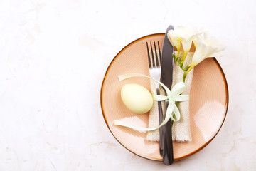 Easter laying table appointments, table setting options. Silverware, tableware items with festive decoration. Fork, knife and flowers. Happy easter holiday.