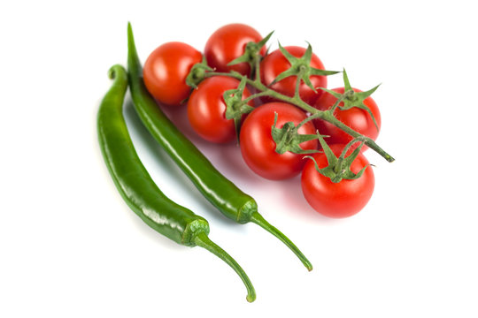 tomatoes and green peppers on a white background