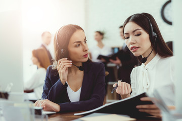 Girls-operators of the call center communicate with each other.