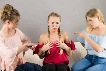 Woman being bullied by two females