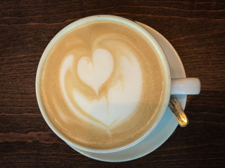 Cup of coffee with milk foam and heart shape