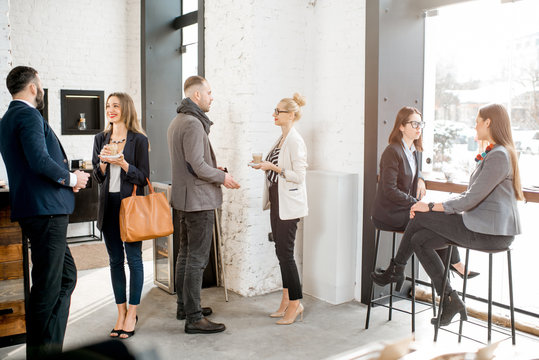 Business People Having A Conversation During The Coffee Break In The Cafe