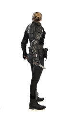 full length portrait of female  soldier wearing black  tactical armour, holding a remote knife,...