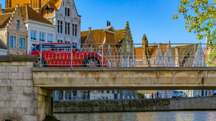 Naklejka premium Belgium, Brugge a car passing on a bridge in the old bruges