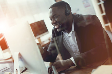 A black guy works as a call center operator.