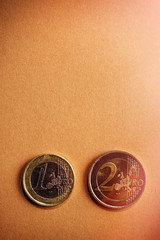 coins one and two euros on a background of cardboard..