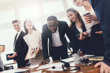 A group of young people holds brainstorming in the office.