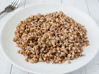 Buckwheat porridge in a plate, healthy food.