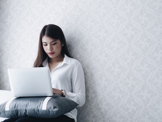 Fototapeta premium Asian woman using tablet in living room.