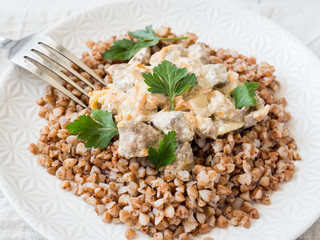 Buckwheat porridge with a side of chicken liver with cream sauce.