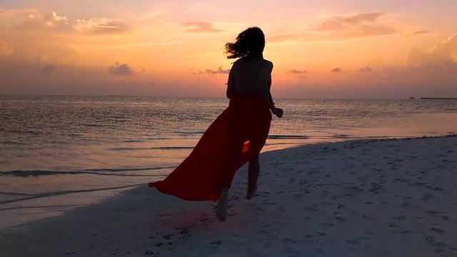 Girl Running on The Beach at Sunset in Slow Motion