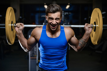 Handsome model young man workout in gym