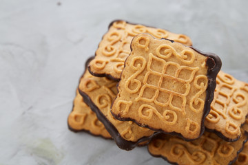 Square biscuits arranged in pattern on light textured background, close-up, shallow depth of field, selective focus.