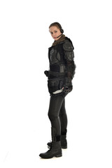 Fototapeta premium full length portrait of female soldier wearing black tactical armour, holding a remote knife, isolated on white studio background.