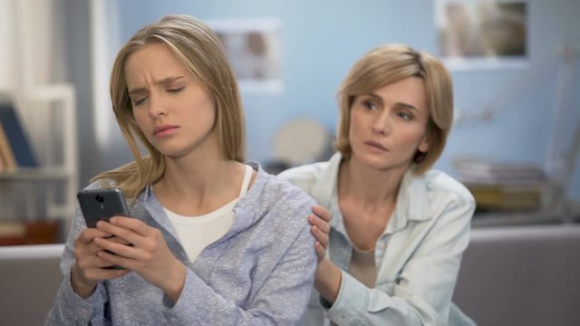 Addicted to smartphone daughter avoiding family talk with mother, naughty child