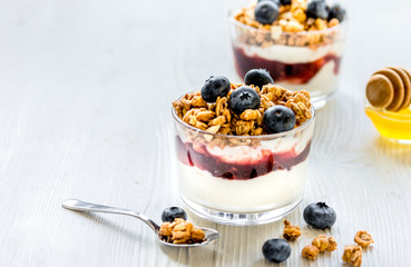 Fitness breakfast with muesli, honey and berries on white table