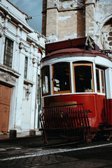 Fototapeta na wymiar Quaint tram passes directly in front of the Se Cathedral in Lisbon. Lisboa Lissabon
