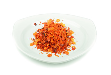 Cayenne pepper in white plate on white background