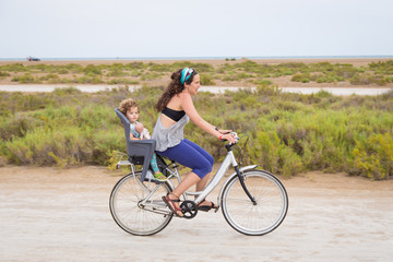 Fototapeta premium Woman riding with a toddler