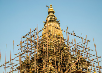 Pigeons on some scaffolding around Krishna temple on Patan Durbar Square, in Patan, Nepal. The temple was damaged by the April 2015 Nepal earthquake.