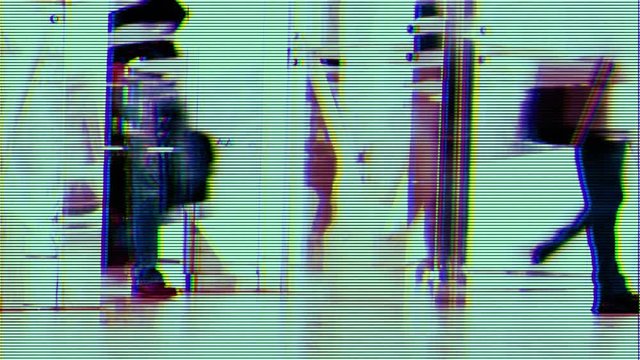 people rushing around at airport terminal with overlayed effect to make it look like cctv security footage.