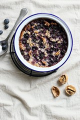 Super seedy vegan baked oatmeal with blueberries and walnuts. Power breakfast for healthy, super food and clean eatind concept. Overhead view
