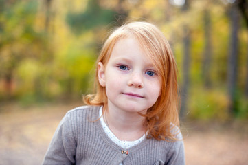 Portrait of a girl with gray eyes closeup outdoor