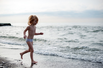 The girl runs along the seashore