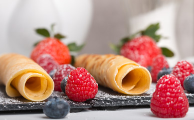 rolled pancakes with fresh fruit and coffee