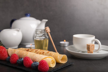 rolled pancakes with fresh fruit and coffee