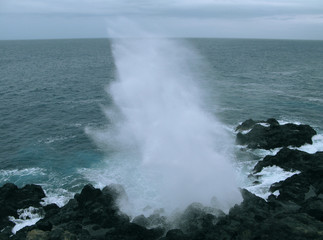 Saint Leu / La Reunion: Le Souffleur is a natural phenomenon on the wild rocky coast caused by the repeated onslaught of the sea swell with an impressive jet of sea-spray