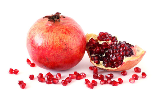 Ripe pomegranate fruit and its half  with seeds on white background. Vegetarian Concept, Organic Vitamins. Organic and Benefit Garnet Fruit.