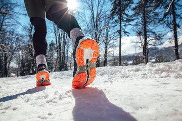  Close up of male feet running along winter road and snow
